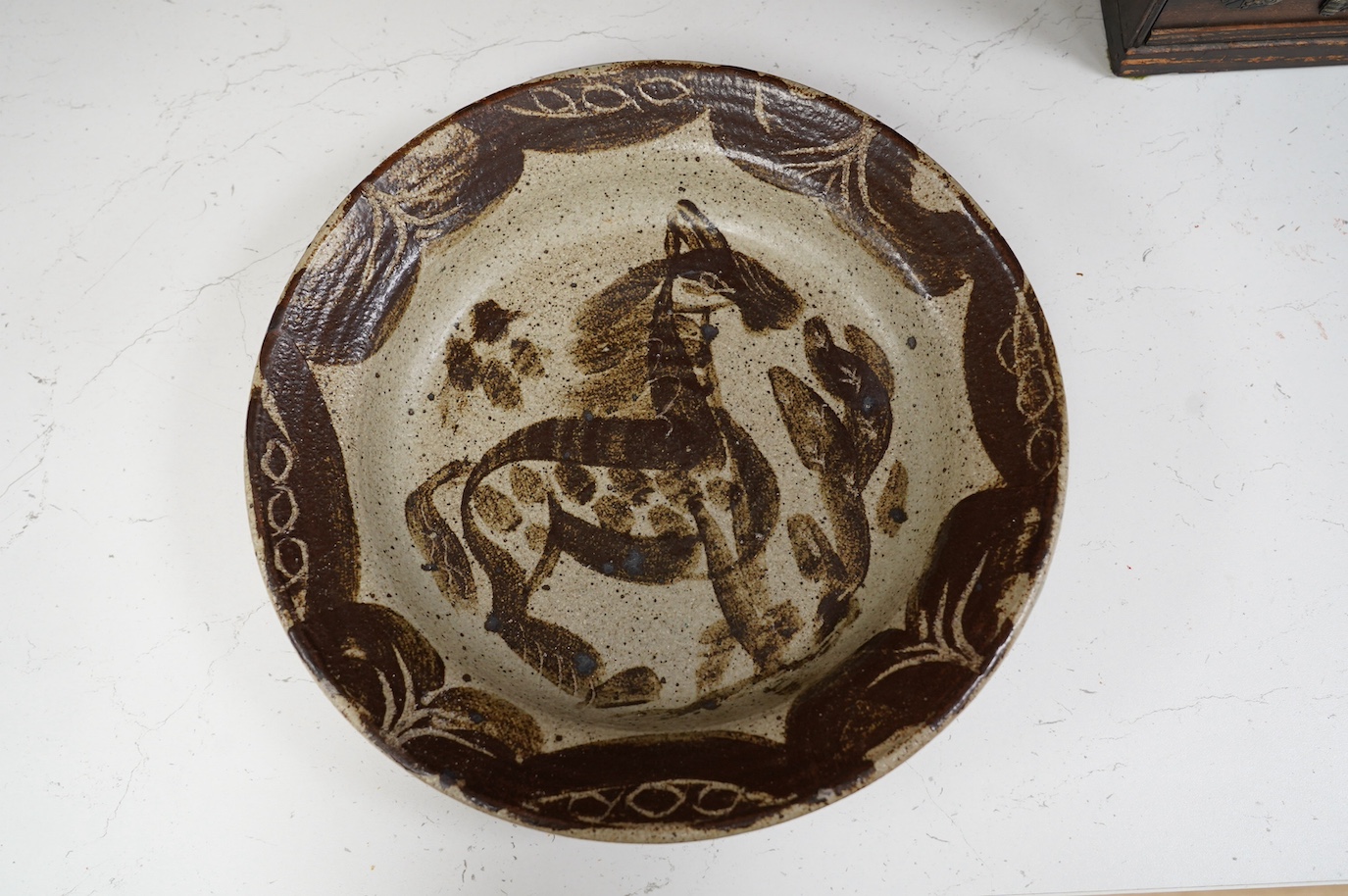 A Studio Pottery ‘horse’ dish stamped PE? on the foot rim, 31cm diameter. Condition - good